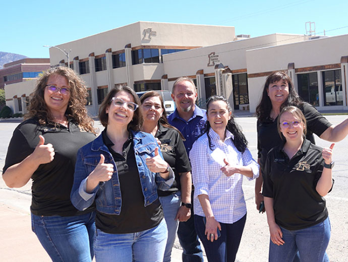 A group of FNB staff posing outside a branch