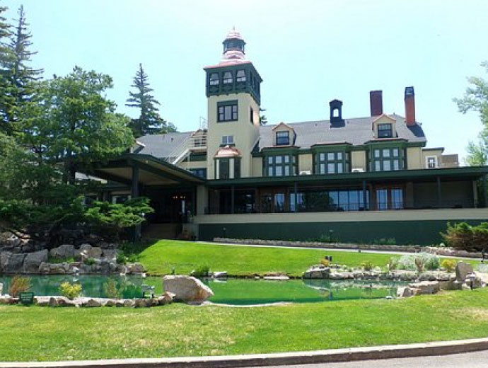 A large house with a pond in front